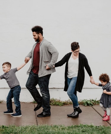 happy family of four holding hands